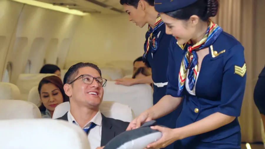 cabin crew give service to passenger in airplane