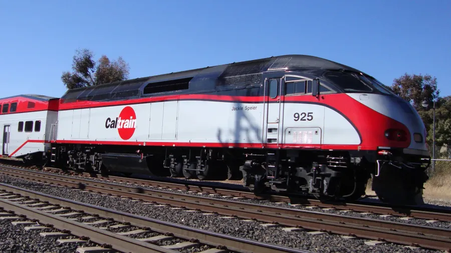 caltrain commuter train moves along tracks during the day