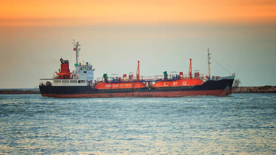cargo ship against colorful sunset