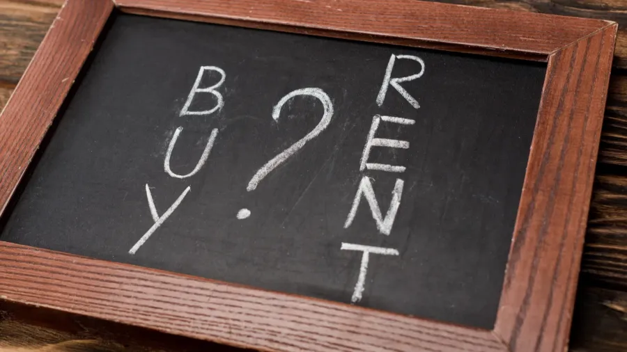 chalkboard with buy and rent lettering on wooden surface
