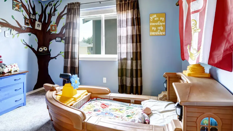 cheerful kids room with boat bed