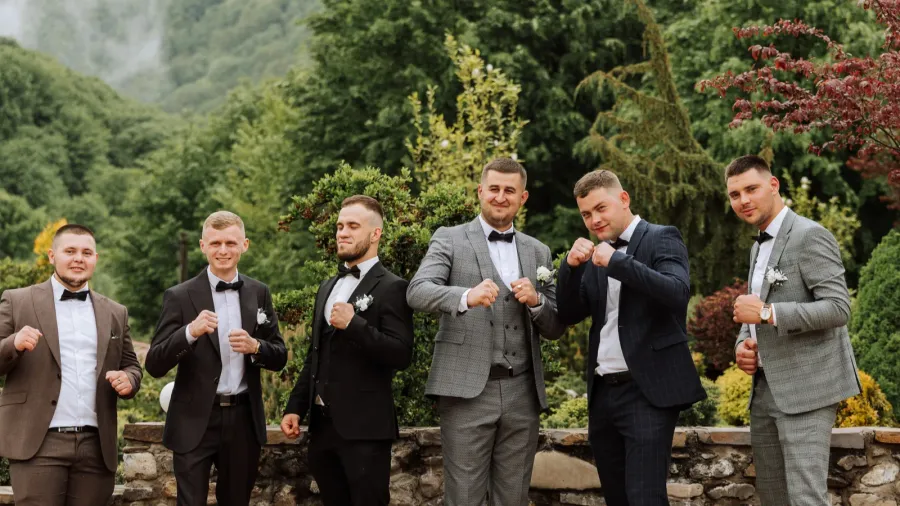 cheerful young energetic witnesses of the groom next to the