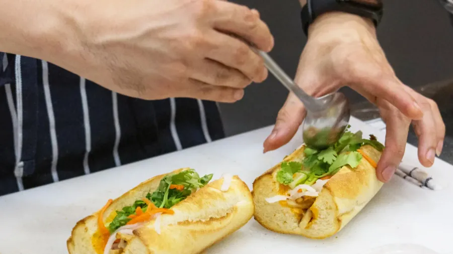 chef prepares sandwich in the kitchen delicious sandwich with v