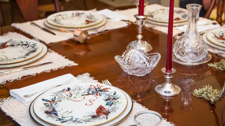 A beautifully decorated dining table with floral plates and candles.