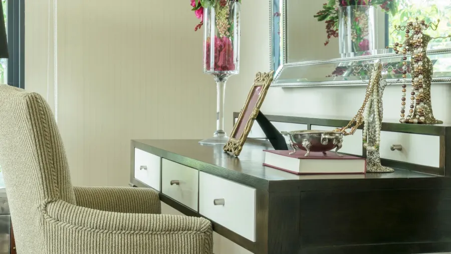 classic chair with jewelry set on wooden dressing table