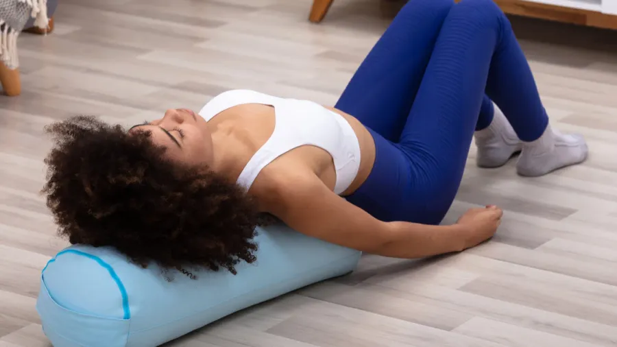 closeup of a young african woman lying on pillow exercising