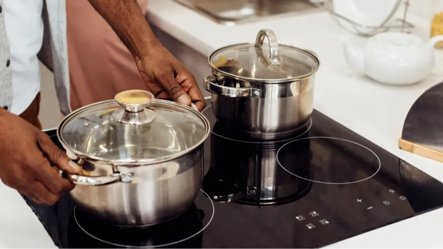 close up of african american man holding pot while woman