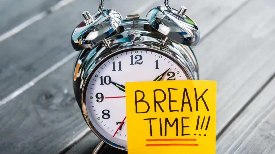 close up of alarm clock with message break time on