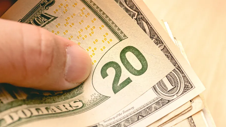 close up of man holding in his hand notes varying