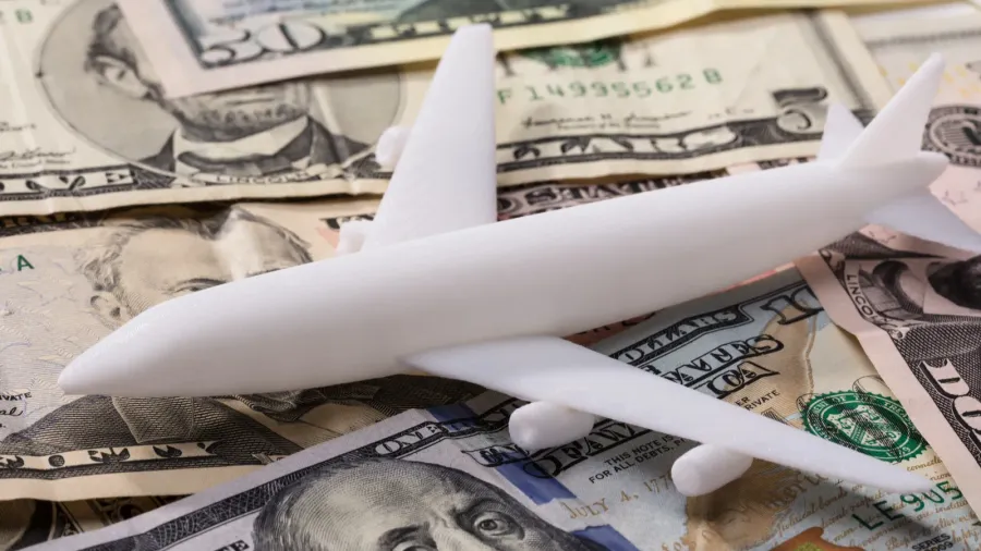 closeup of white airplane on dollar banknotes