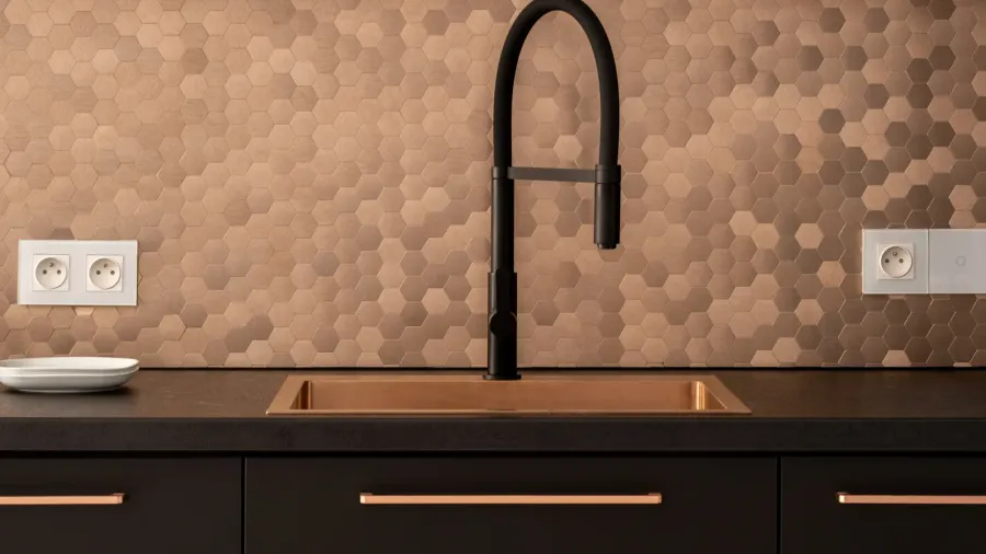 closeup on elegant kitchen with black countertop furniture and tap