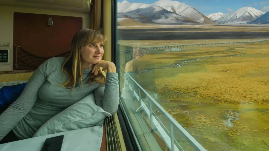 close up smiling woman looks at the landscape while riding