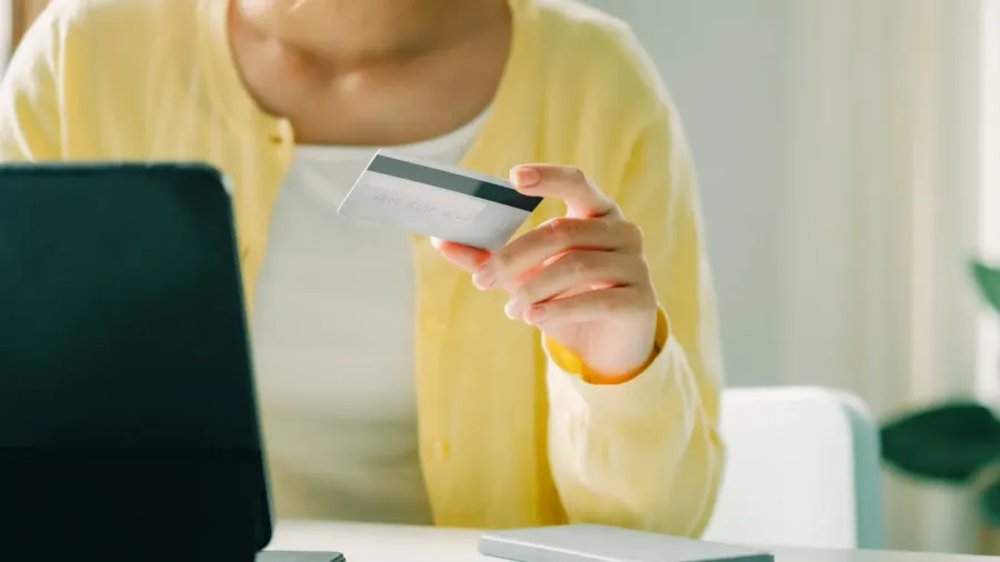 close up woman using credit card for purchasing and shopping