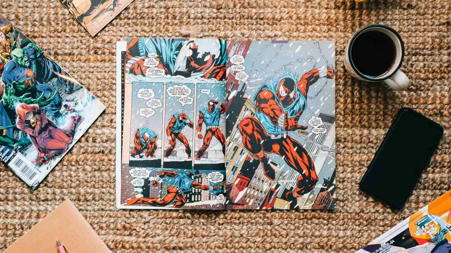 Top shot of comic book and manga magazine placed on jute rug on floor along with mobile phone and cup of coffee.