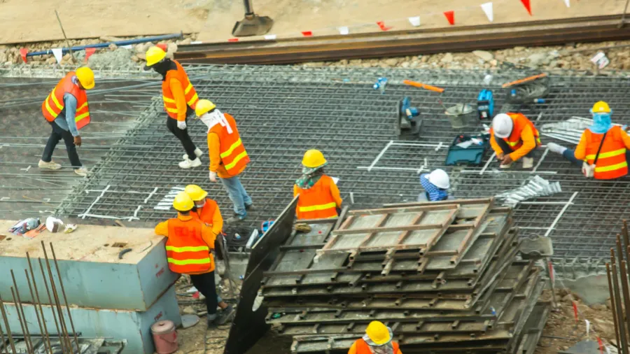 construction workers are working on steel structures to prepare concrete