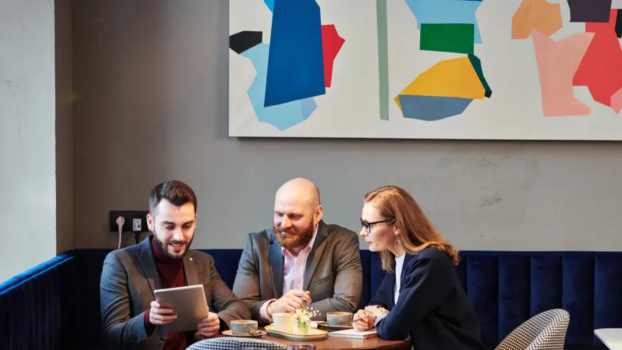 content young business people watching online presentation on tablet at