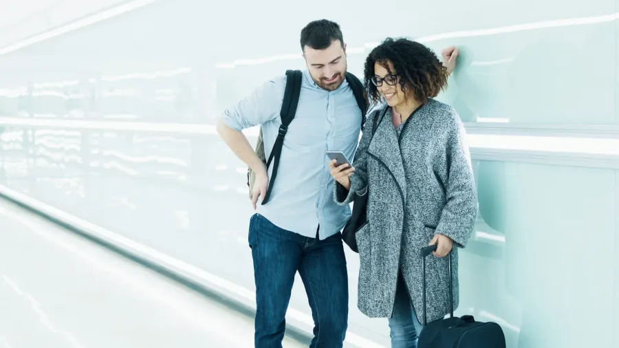 couple ready to go on vacation using travel app on