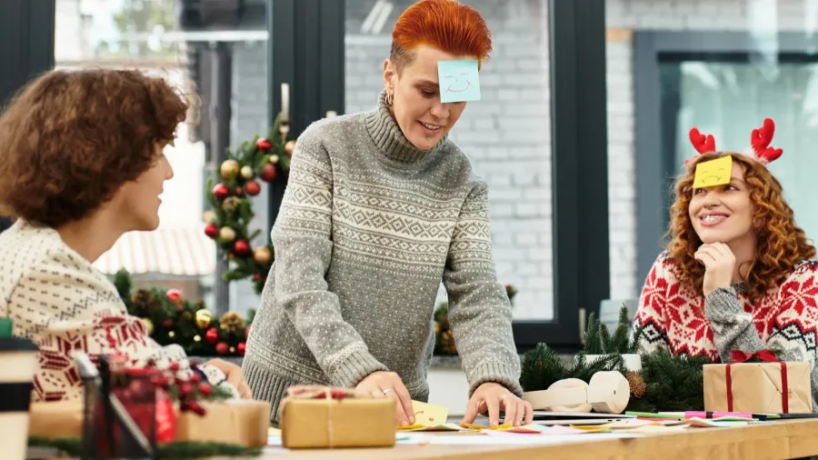 coworkers joyfully celebrate christmas with games and decorations in their