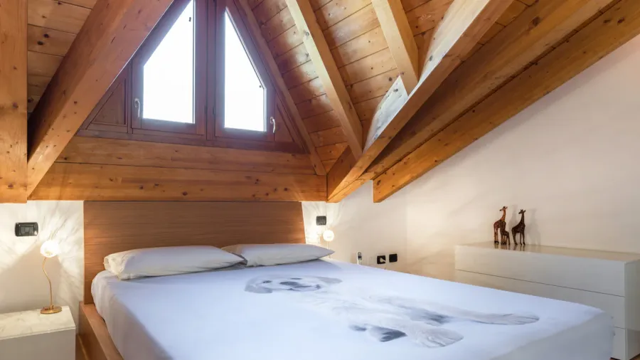 Cozy Italian style bedroom with exposed beams.