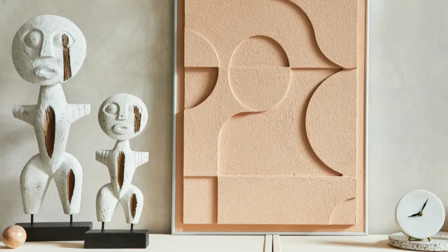 Abstract sculptural decor in a modern beige living room.