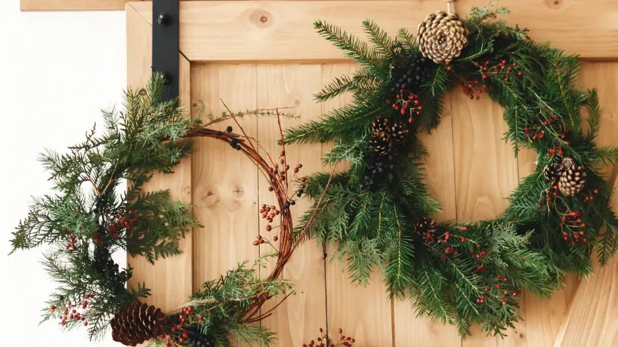 creative natural and different christmas wreaths hanging on stylish rural