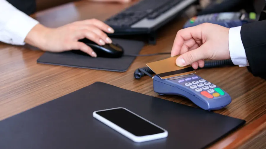 cropped image of businessman paying with credit card at reception