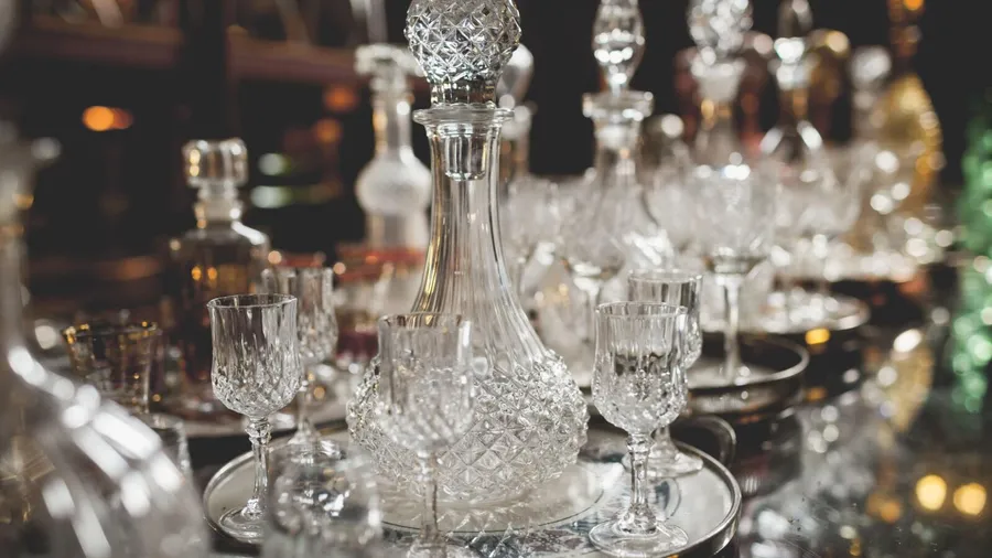 Beautiful crystal decanter and glassware on a silver tray.