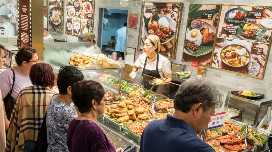 customers buy prepared meal on a food court in the