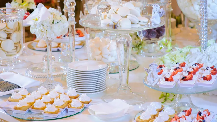 A dessert bar with macaroons, pastries, and other sweet treats beautifully arranged on a table.