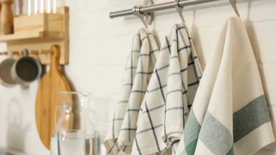 different clean towels hanging on rack in kitchen