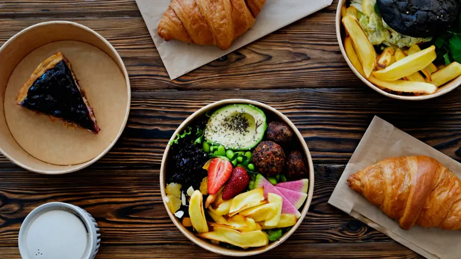 different takeout food on wooden kitchen table hawaiian vegan poke