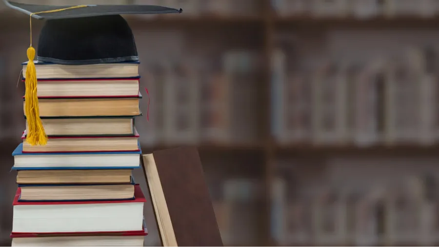 digital composite of books and graduation hat in education library