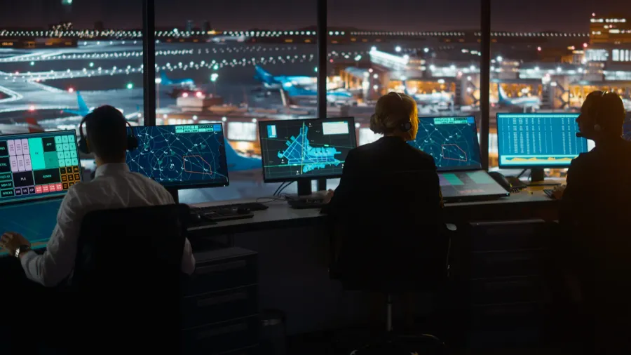 diverse air traffic control team working in modern airport tower