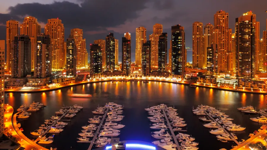 dubai marina at dusk showing numerous skyscrapers of jlt