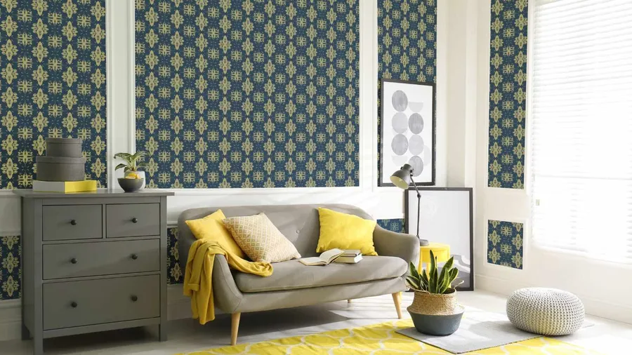 A stylish living room with patterned wallpaper, a gray couch, and vibrant accents.