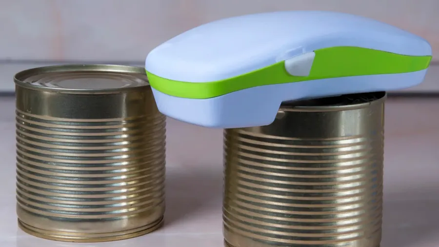 electric can opener and canned goods on kitchen table