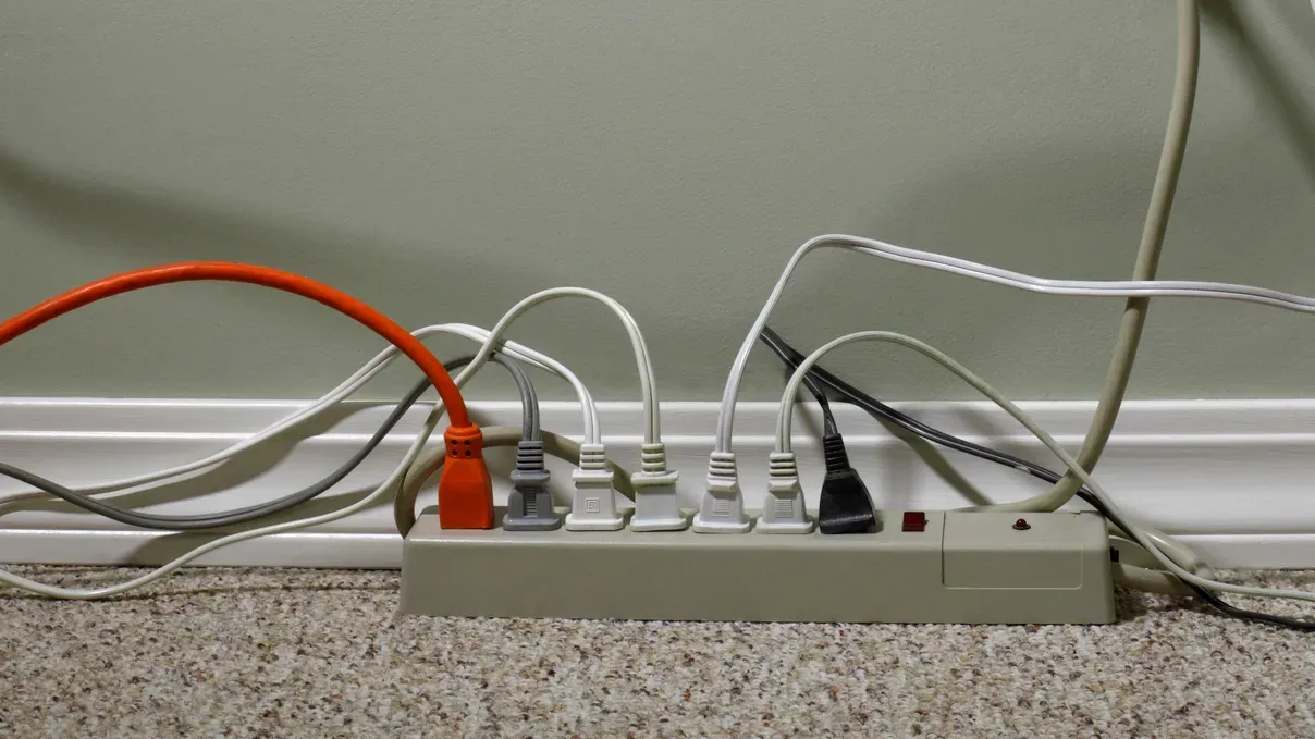 electrical outlet overloaded with wires