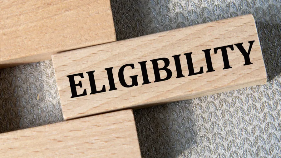 eligibility  word on a wooden bar on a gray