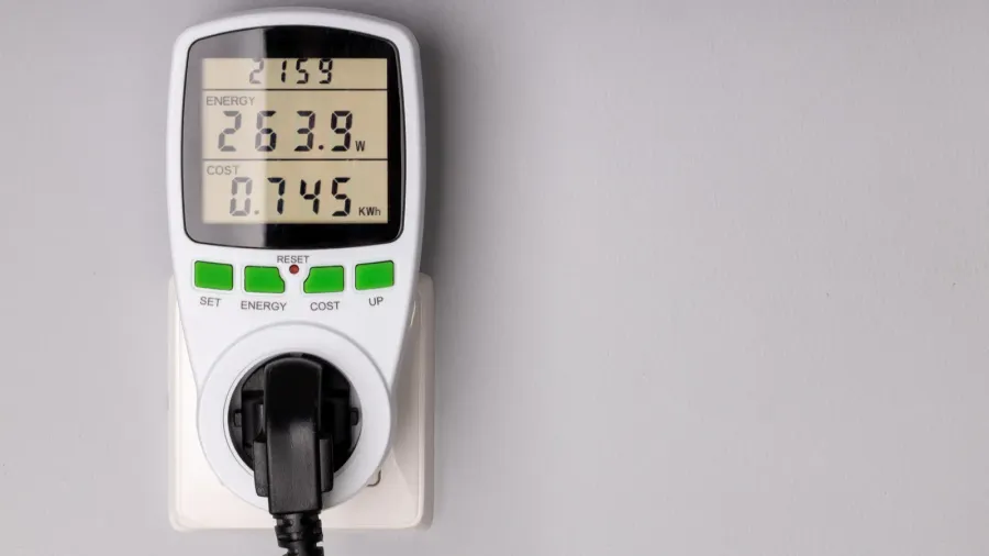 An energy monitoring plug displaying power consumption from the plugged in device.