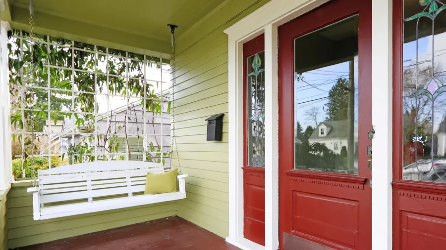 entrance porch in red and green color with hanging swing