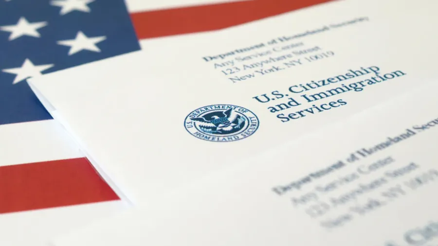 envelopes with letter from uscis on united states flag from