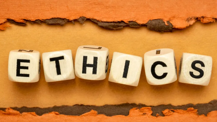 ethics word  wooden cubes on handmade paper in