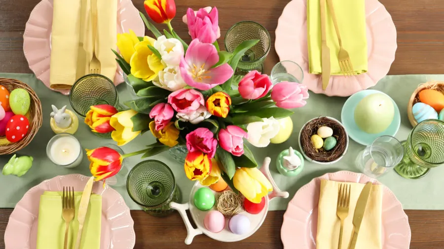 festive easter table setting with beautiful flowers and painted eggs