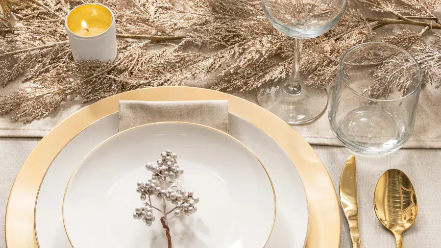 Festive elegance dining table glimmering goldrimmed porcelain plates on golden.