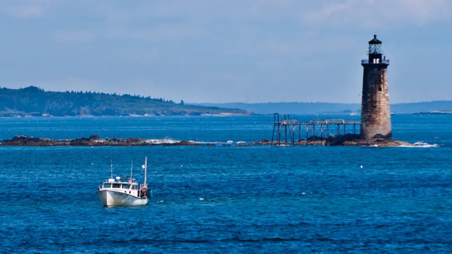 fishing boat with maine lighthouse