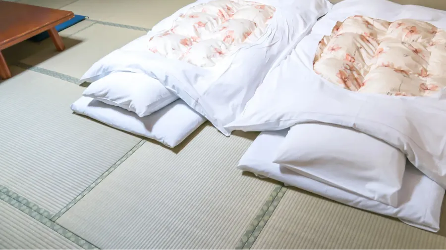 futon a japanese quilted mattress rolled out on the floor