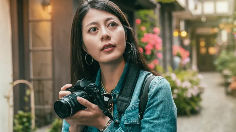 girl taking photos in a alley surrounded by the vintage