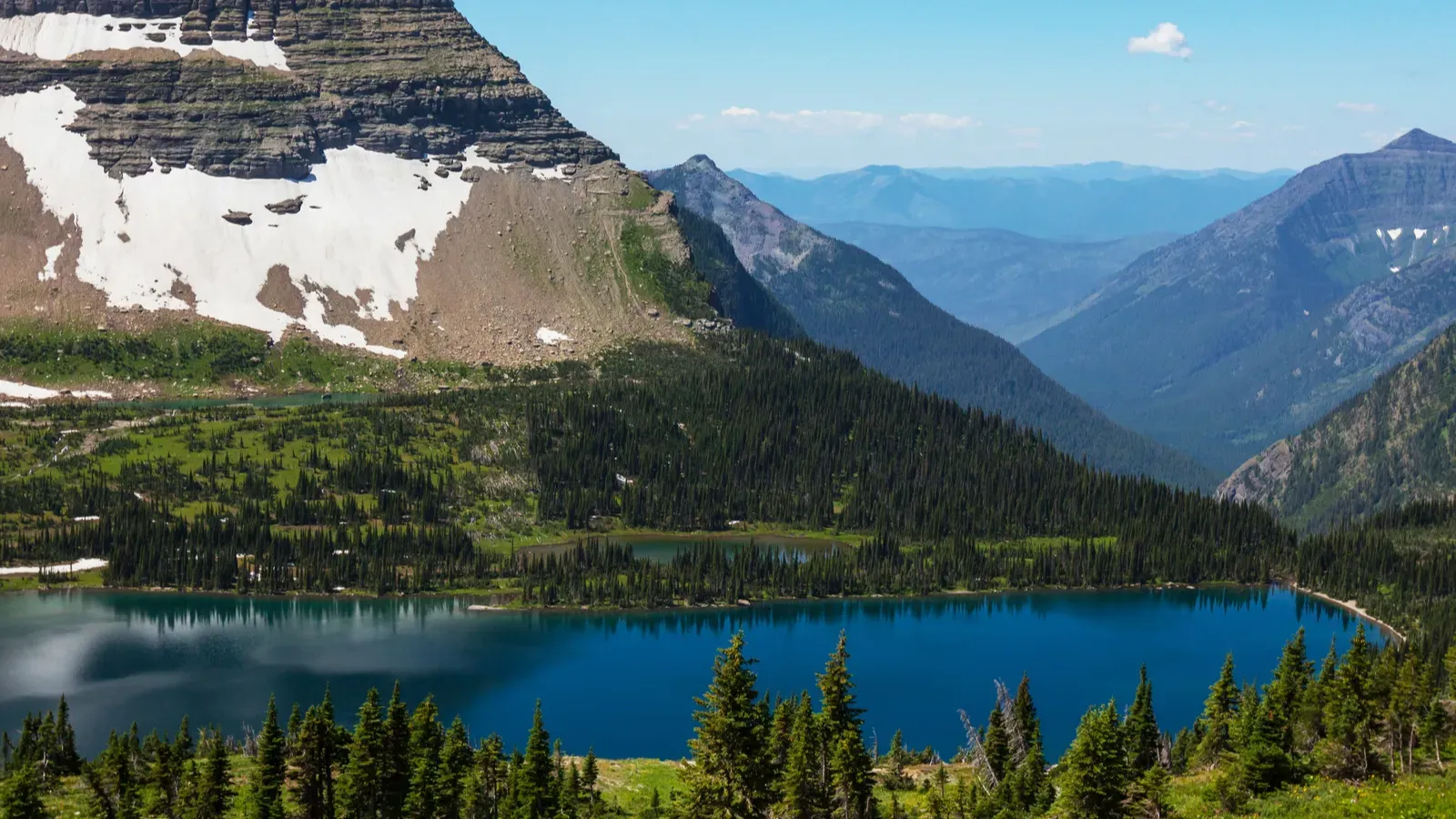 A landscape view of a lake and mountains within Glacier National Park in Montana, USA. 