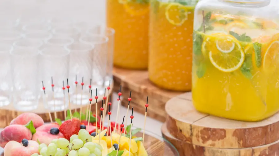glass bank of lemonade with sliced citrus fruits on a