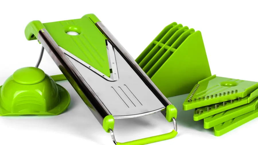 grater with green nozzles and holder of vegetables